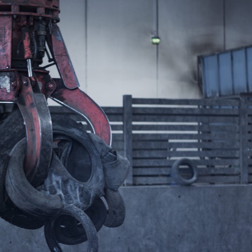 Tires entering pre-shredder at Genan's Houston tire recycling facility