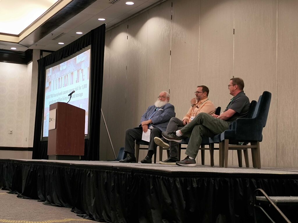 Panelists speaking on a stage